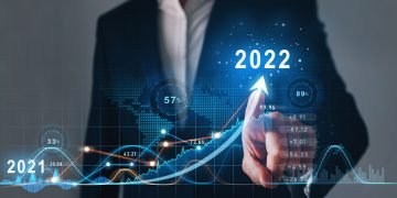 Businessman draws  increase arrow graph corporate future growth year 2021 to 2022.   Development to success and motivation