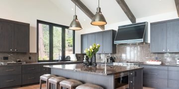 Kitchen island with four stools and two pendant lights above