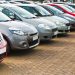 Line up of various types of used cars for sale on a motor dealers forecourt all marques removed