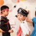 Halloween day, children wearing costumes playing in the room.